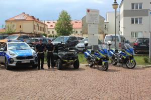 Pojazdy policyjne dwa motocykle, quad oraz oznakowany radiowóz