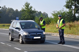 Policjanci rozdają ulotki promujące bezpieczeństwo