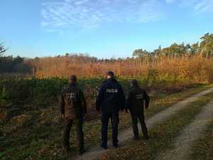 Policjant wraz ze Strażnikami Leśnymi kontrolują tereny leśne